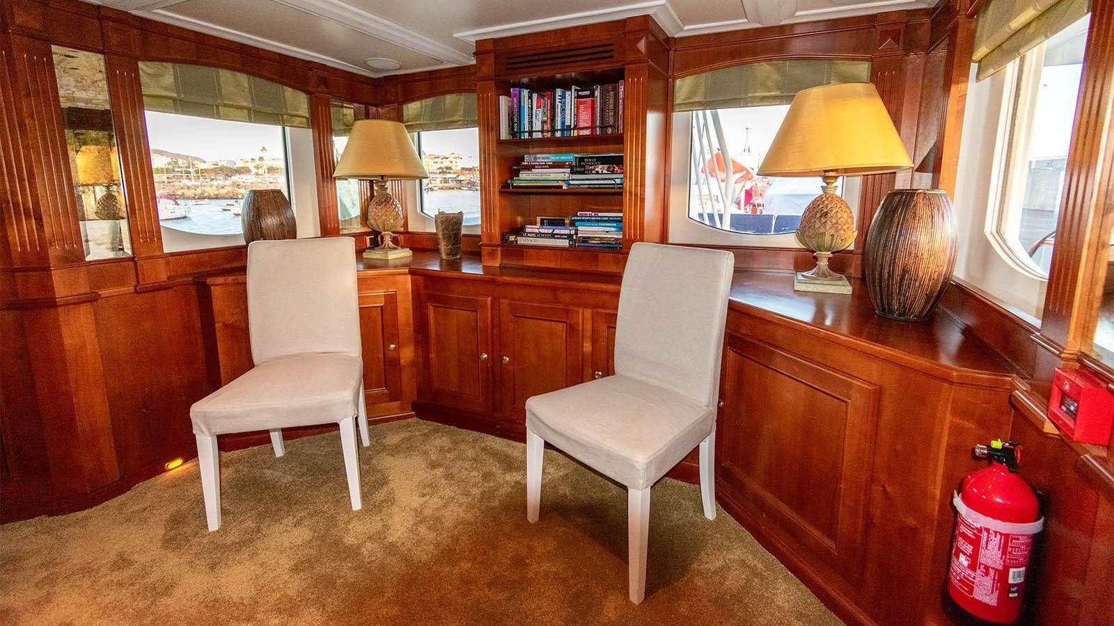 a room with a table and chairs aboard CHANTAL Yacht for Sale