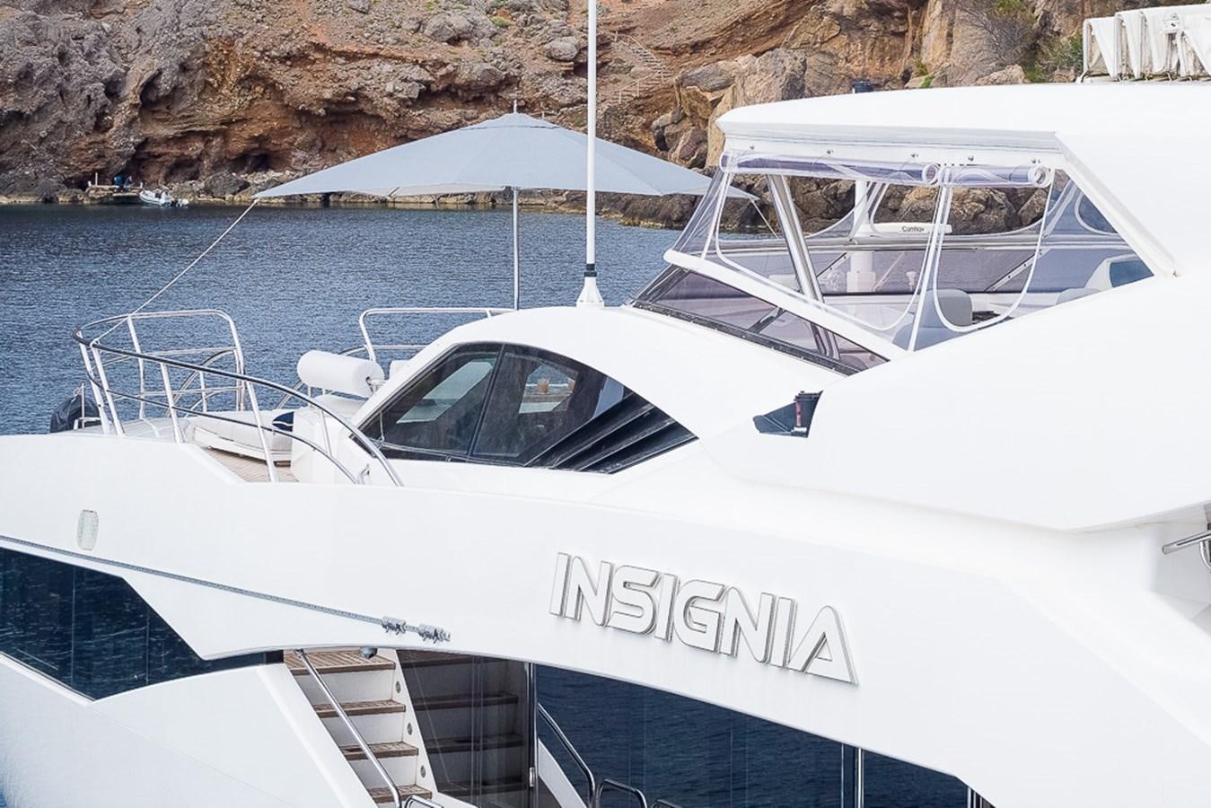 a white boat with a white canopy aboard INSIGNIA Yacht for Sale