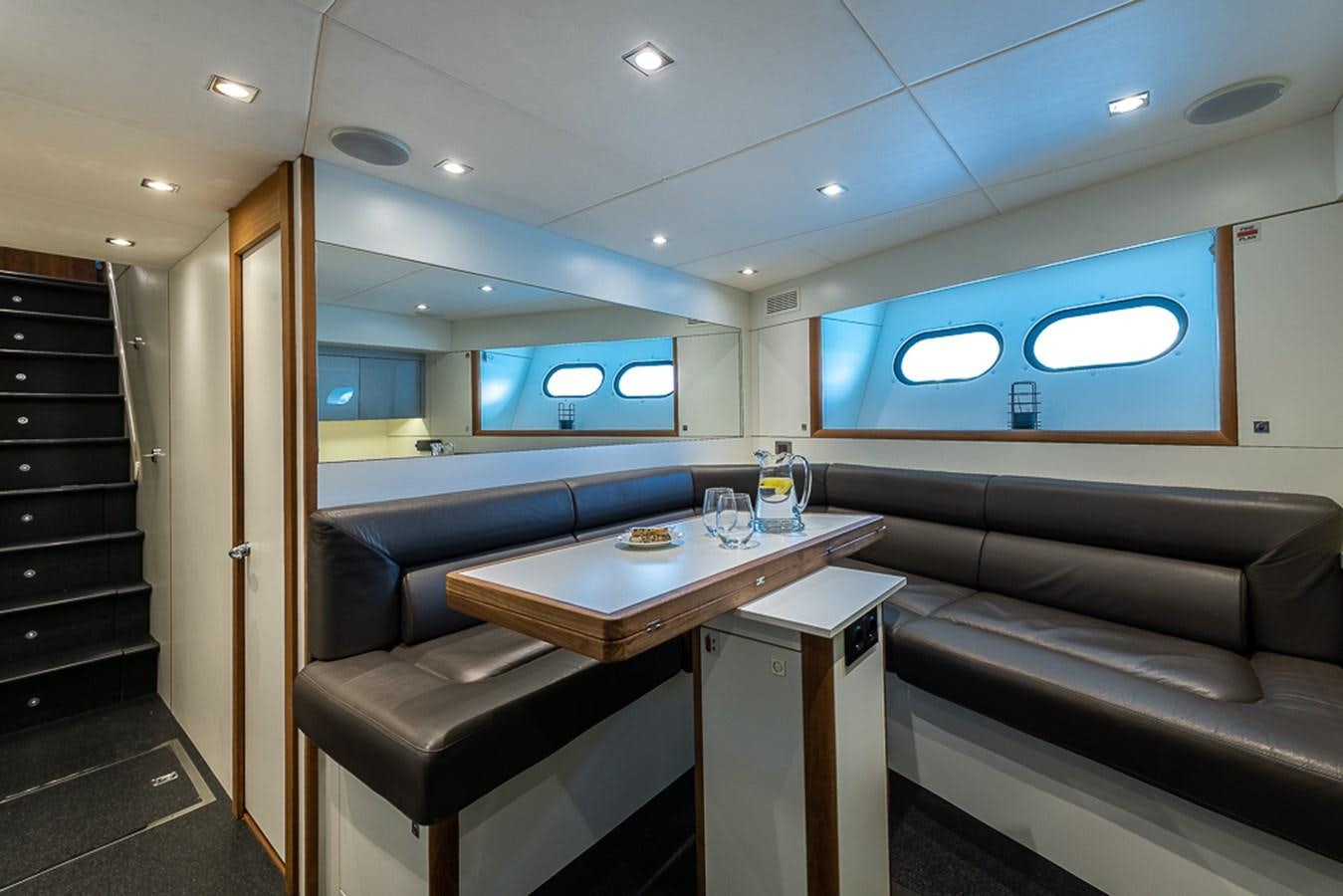 a room with a couch and a table and a tv aboard INSIGNIA Yacht for Sale