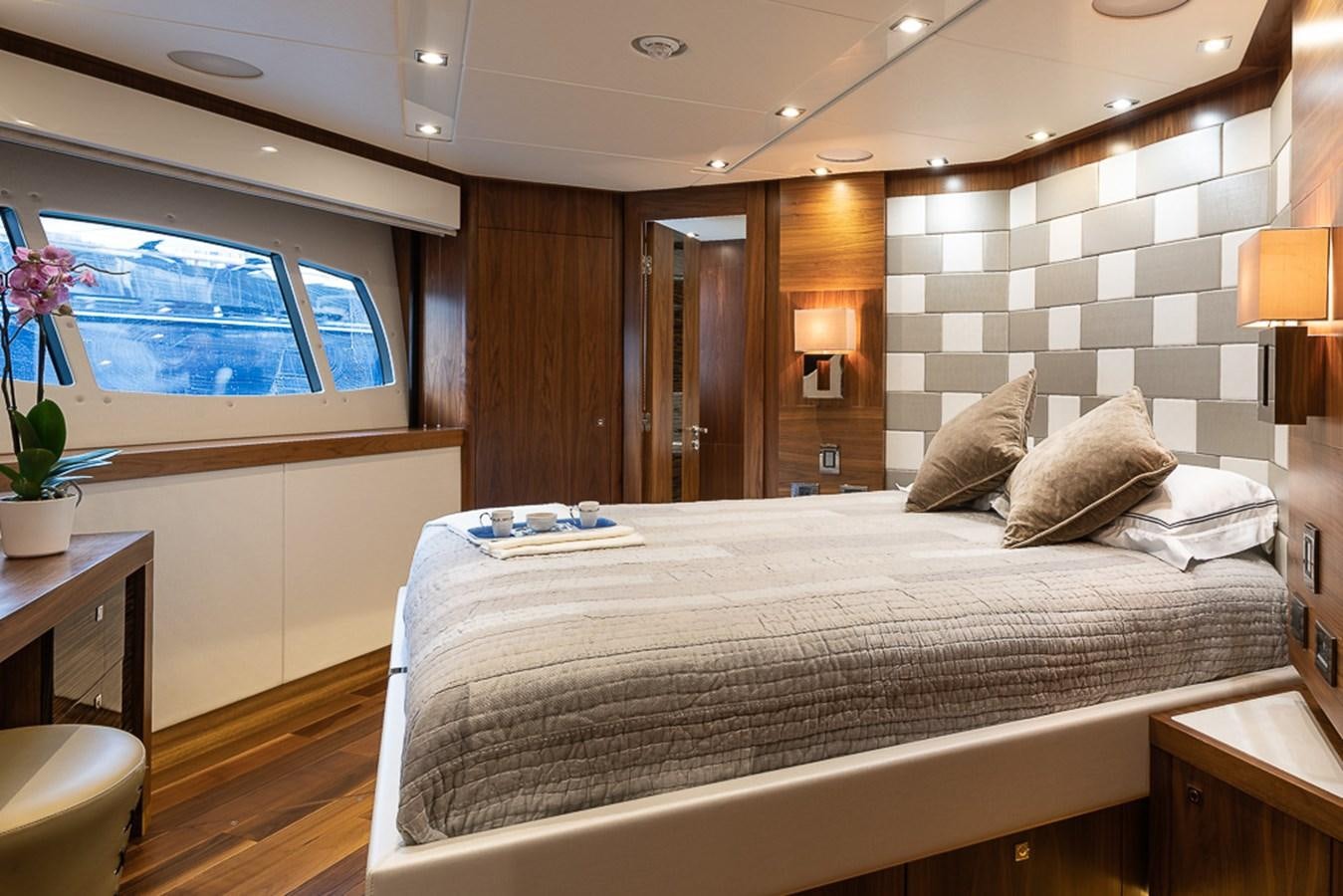a large bedroom with a large bed aboard INSIGNIA Yacht for Sale