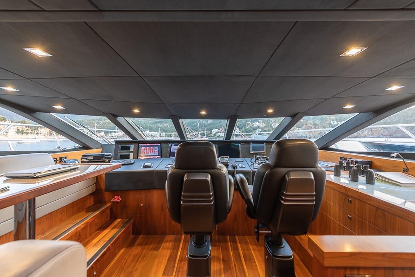 a room with a desk and chairs aboard INSIGNIA Yacht for Sale