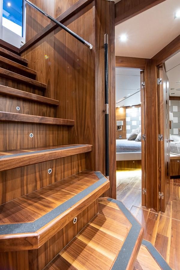 a wood staircase in a room aboard INSIGNIA Yacht for Sale