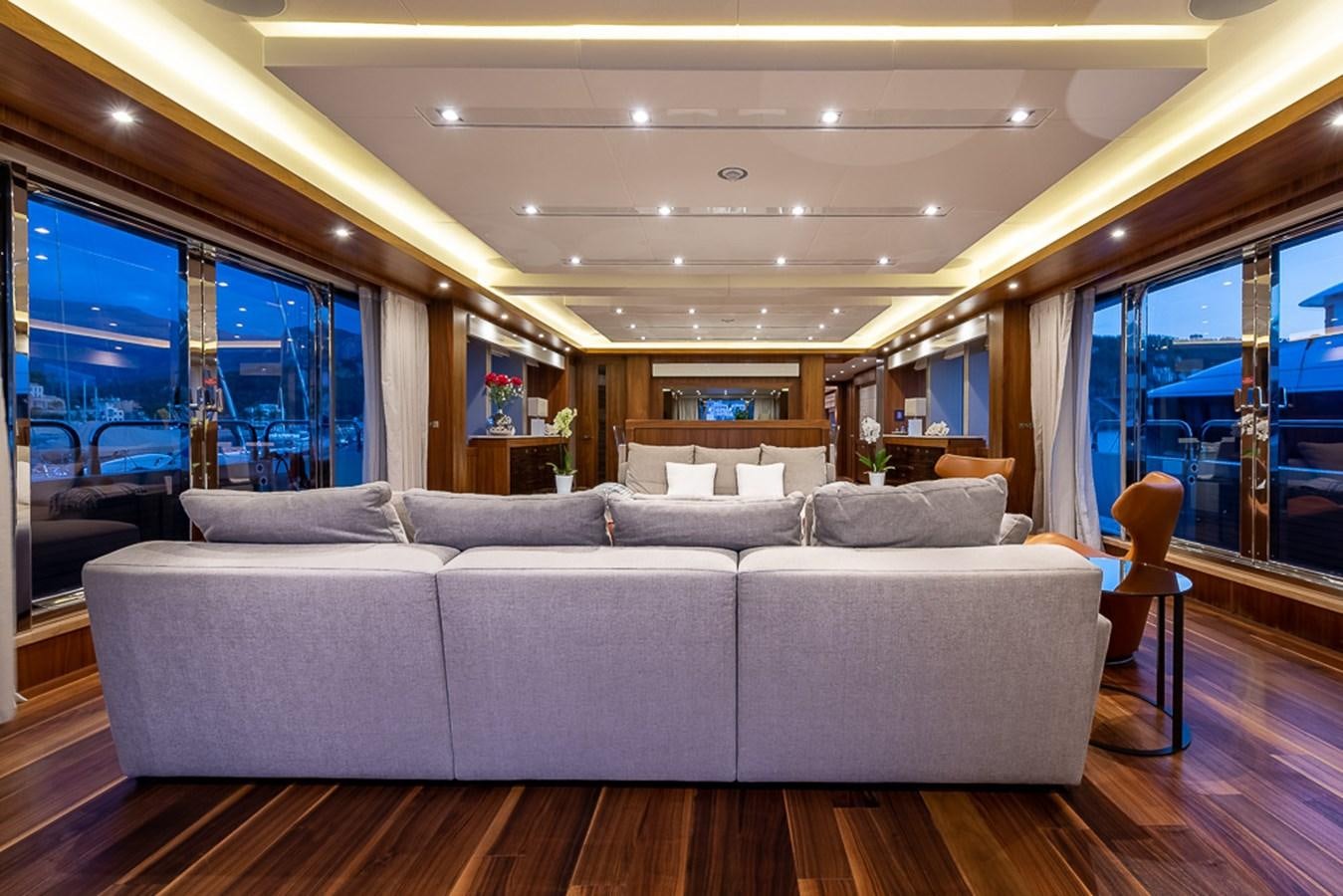 a living room with a large sofa aboard INSIGNIA Yacht for Sale