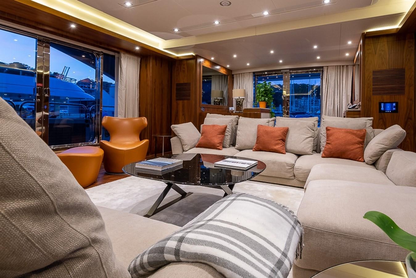a living room with a couch and a table aboard INSIGNIA Yacht for Sale