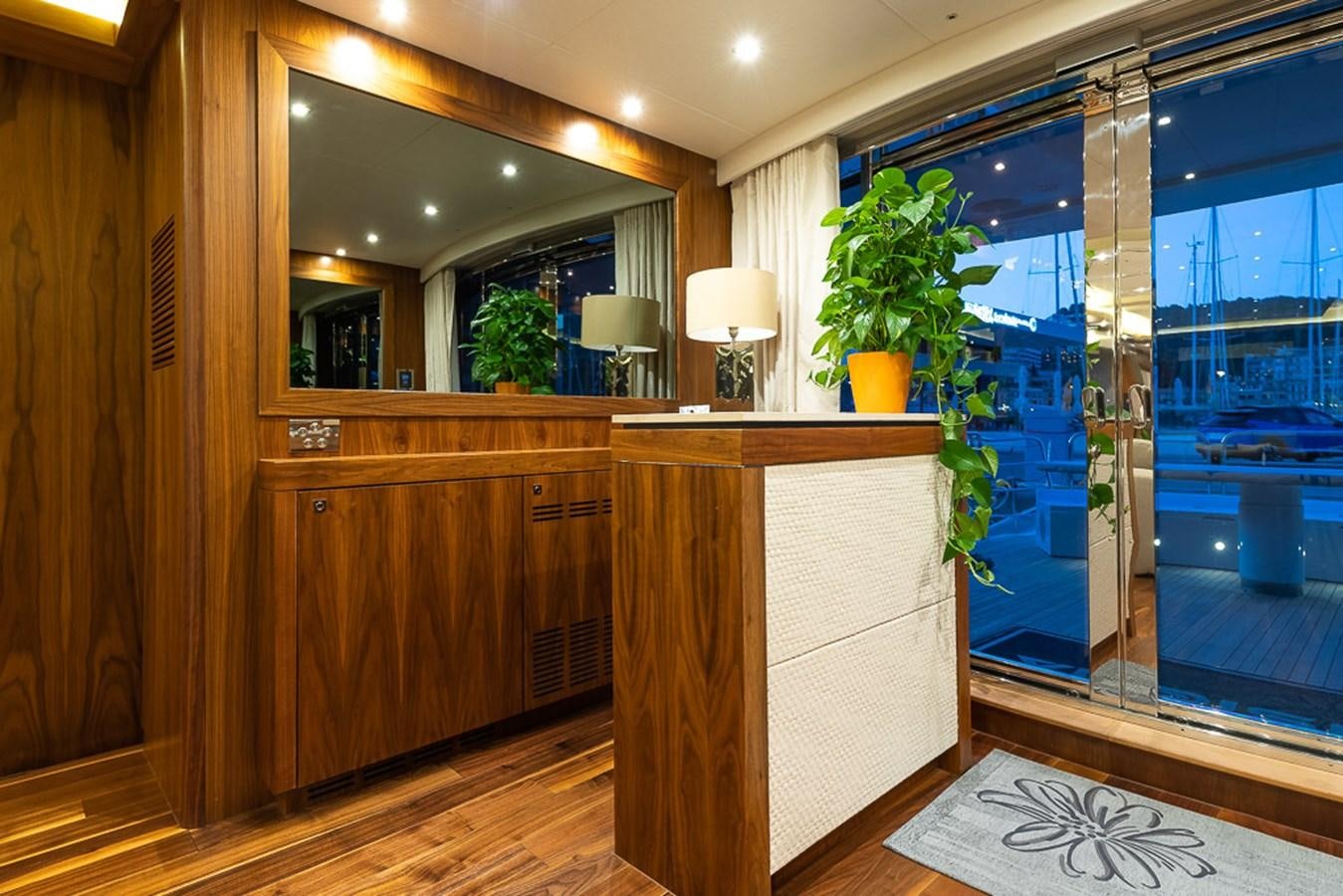 a room with a large mirror and a plant in the window aboard INSIGNIA Yacht for Sale
