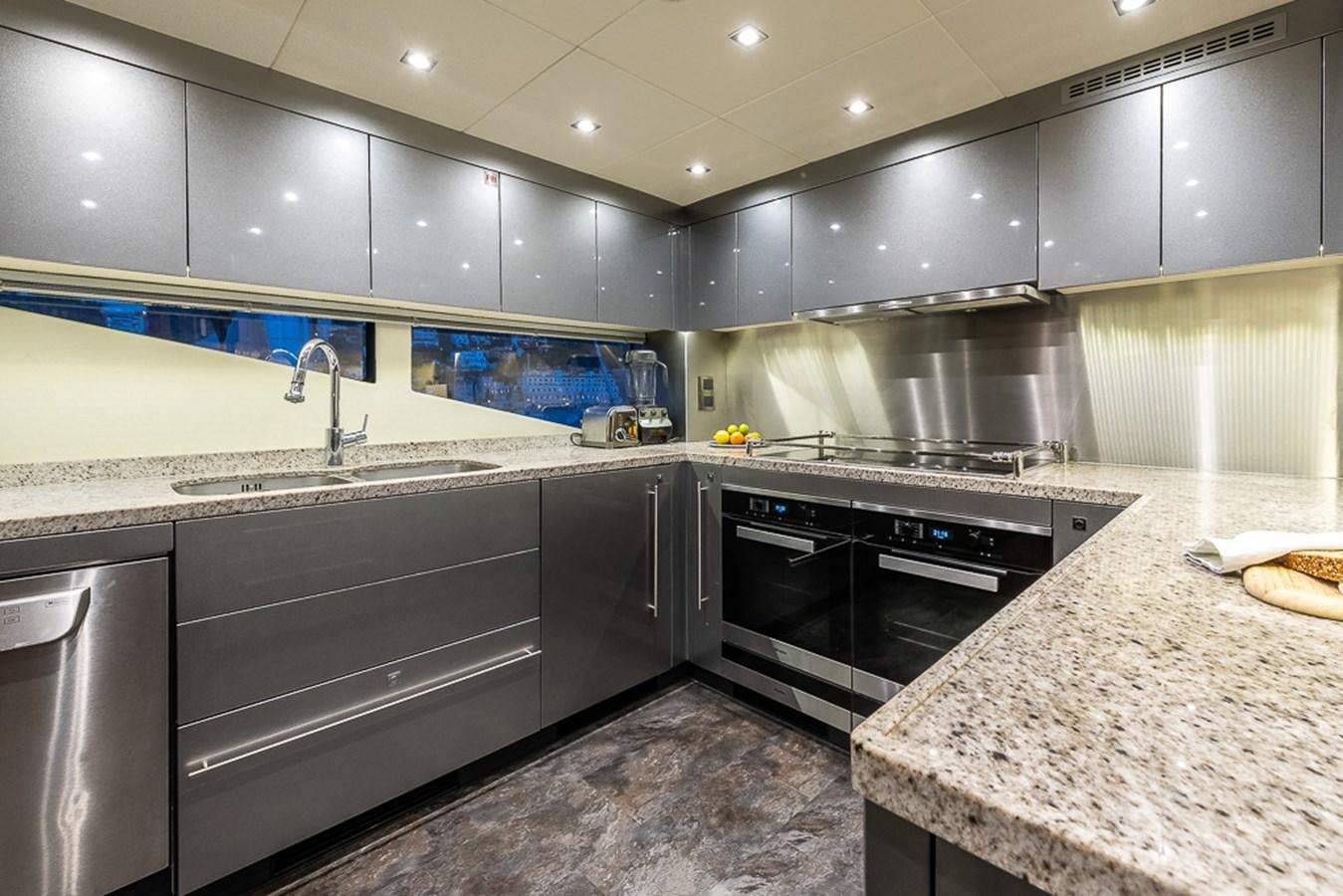 a kitchen with stainless steel appliances aboard INSIGNIA Yacht for Sale