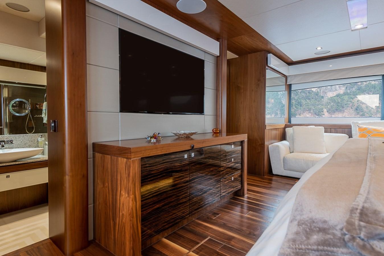 a room with a tv and a bed aboard INSIGNIA Yacht for Sale