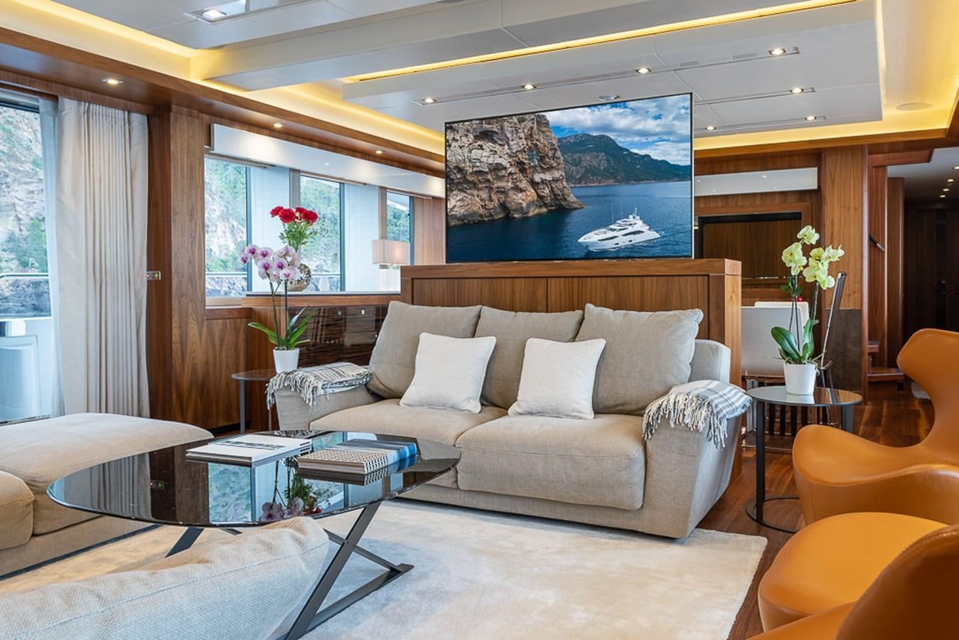 a living room with a white couch aboard INSIGNIA Yacht for Sale