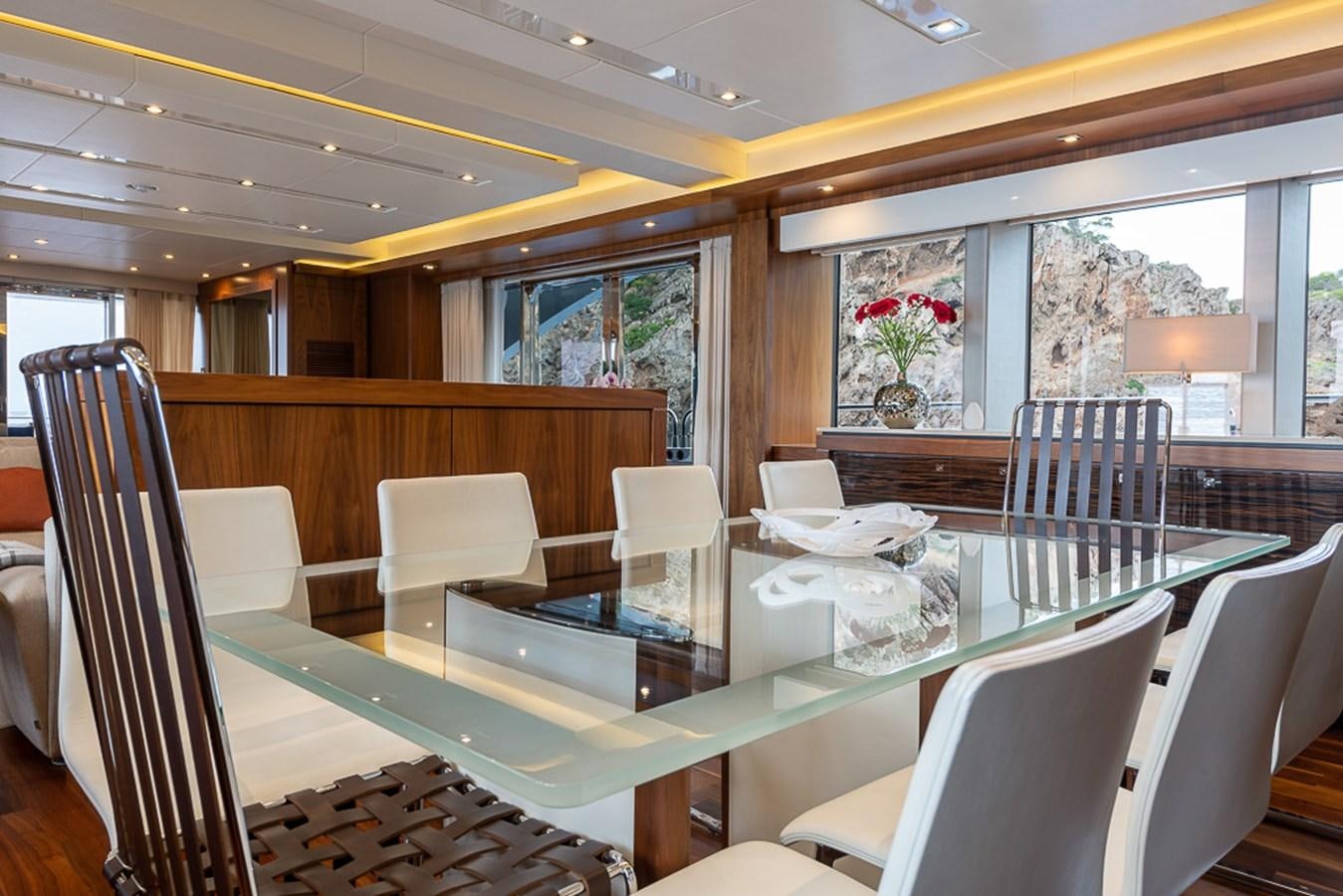a room with tables and chairs aboard INSIGNIA Yacht for Sale