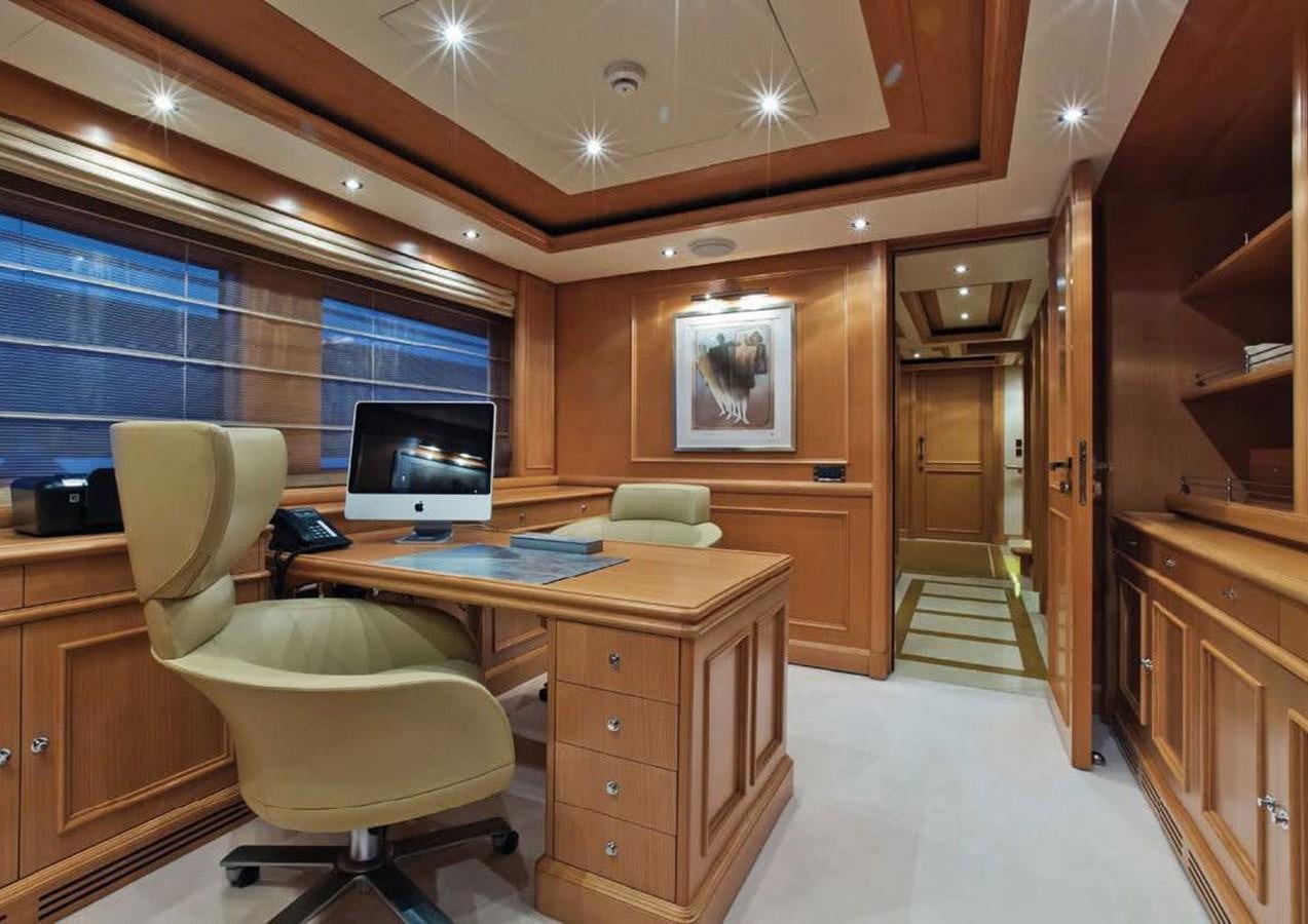 a room with a desk and a chair aboard HANA Yacht for Charter
