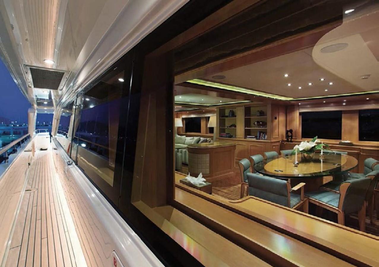 a room with tables and chairs aboard HANA Yacht for Charter