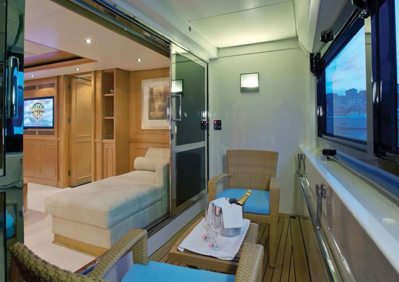 a room with a bed and a table aboard HANA Yacht for Charter