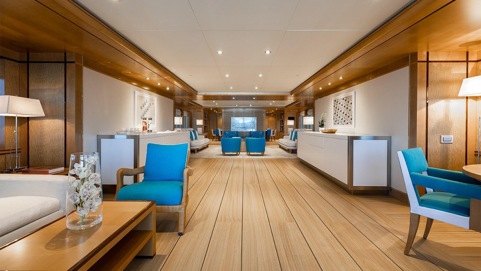 a living room with a wood floor aboard CLELIA III Yacht for Charter