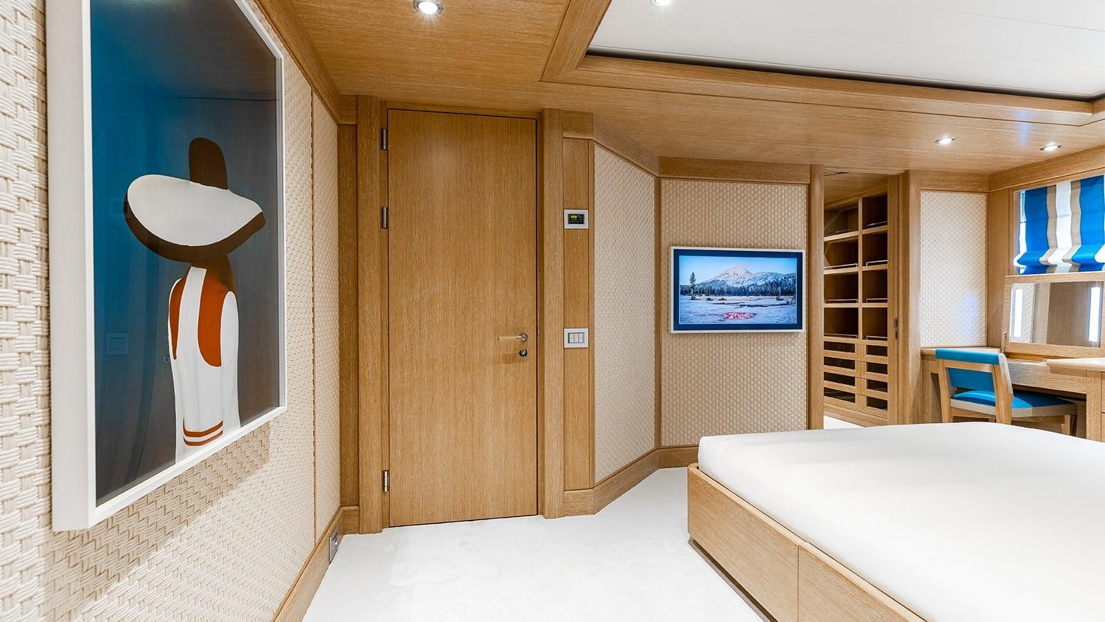 a room with a bed and a desk aboard CLELIA III Yacht for Charter