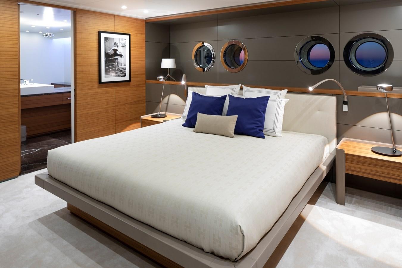 a bed with a white comforter aboard BOLD Yacht for Sale