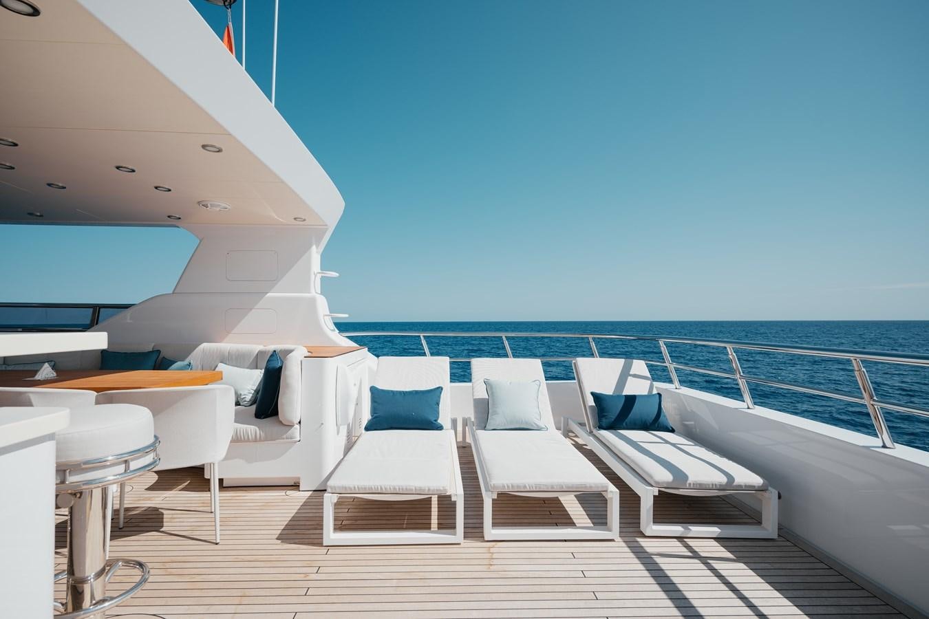 a lounge area with chairs and a pool aboard SEAL Yacht for Sale