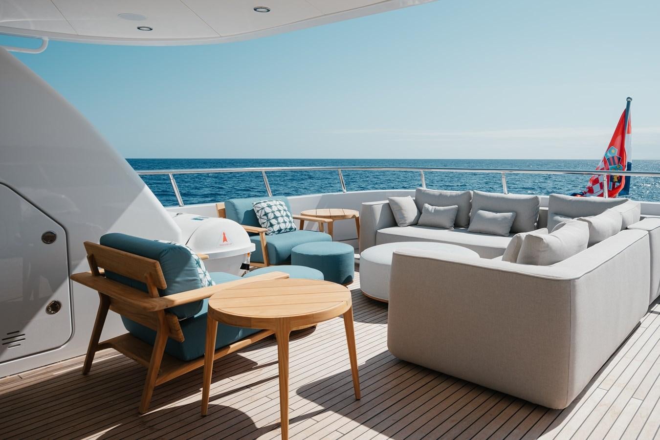 a room with a couch and a table and chairs aboard SEAL Yacht for Sale
