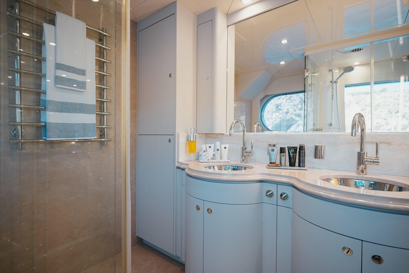 a bathroom with a sink and a shower unit aboard SEAL Yacht for Sale