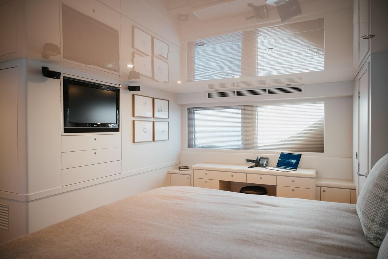 a bedroom with a bed and a tv aboard SEAL Yacht for Sale