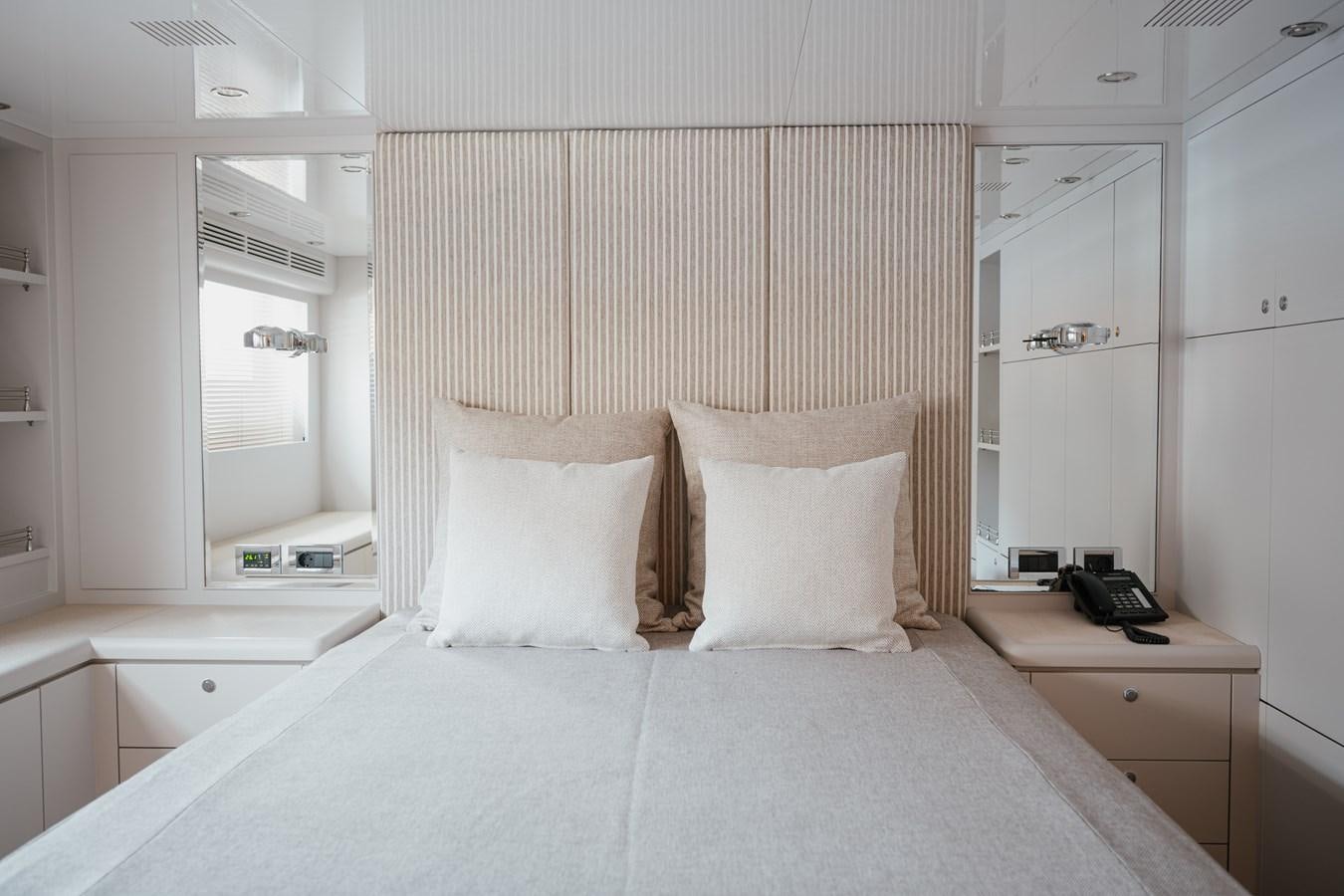 a bed with white sheets aboard SEAL Yacht for Sale