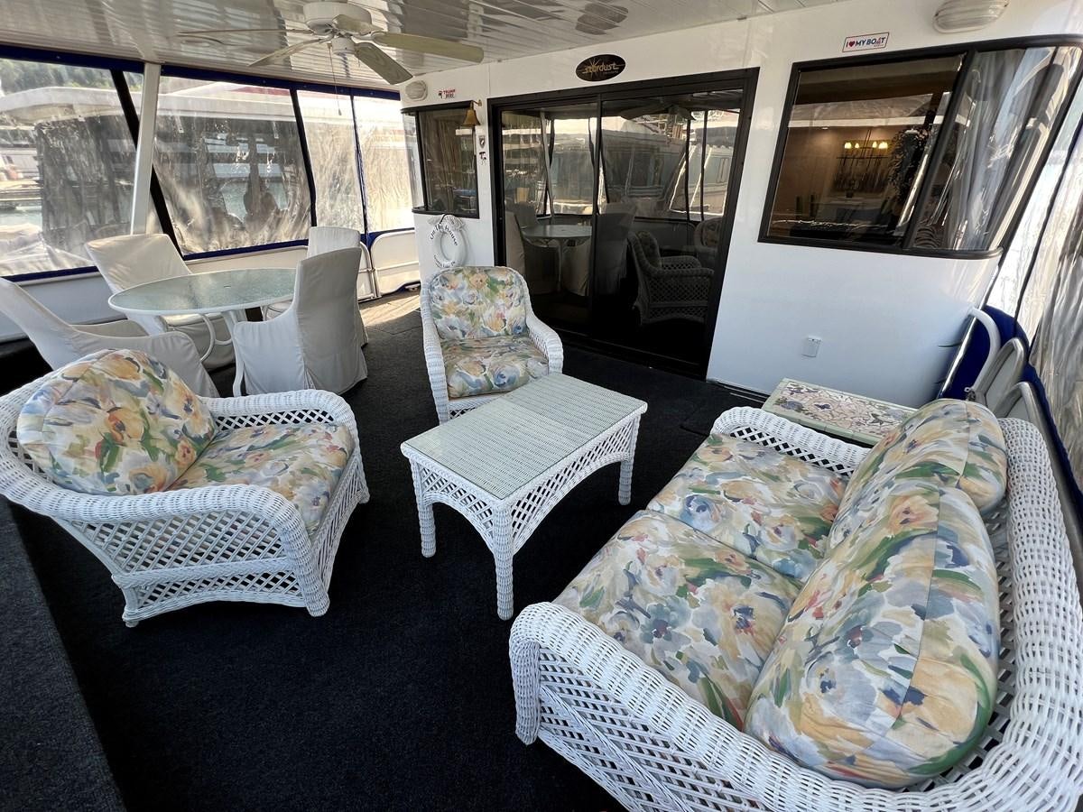 a room with couches and chairs aboard 2010/1995 STARDUST 20 X 95WB NLST Yacht for Sale