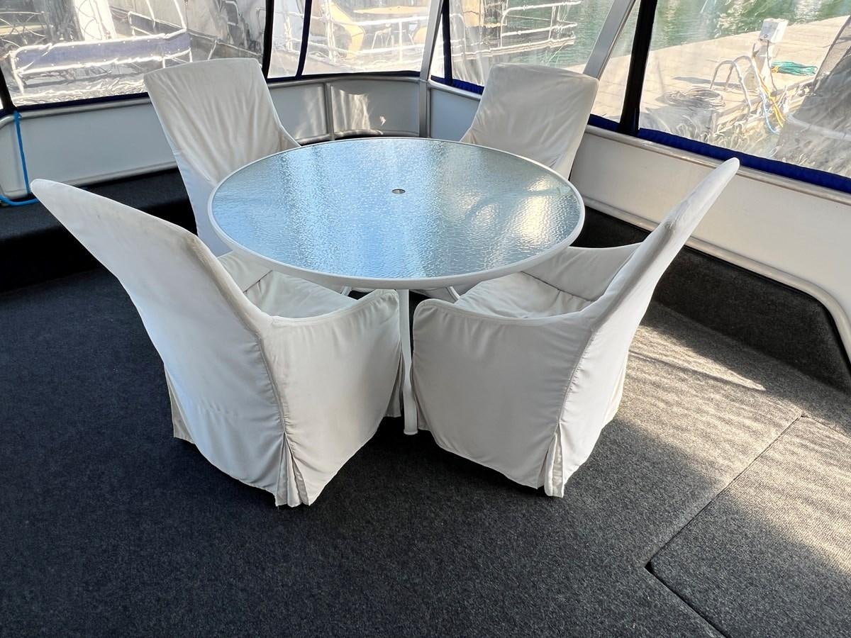 a couple of white chairs on a table aboard 2010/1995 STARDUST 20 X 95WB NLST Yacht for Sale