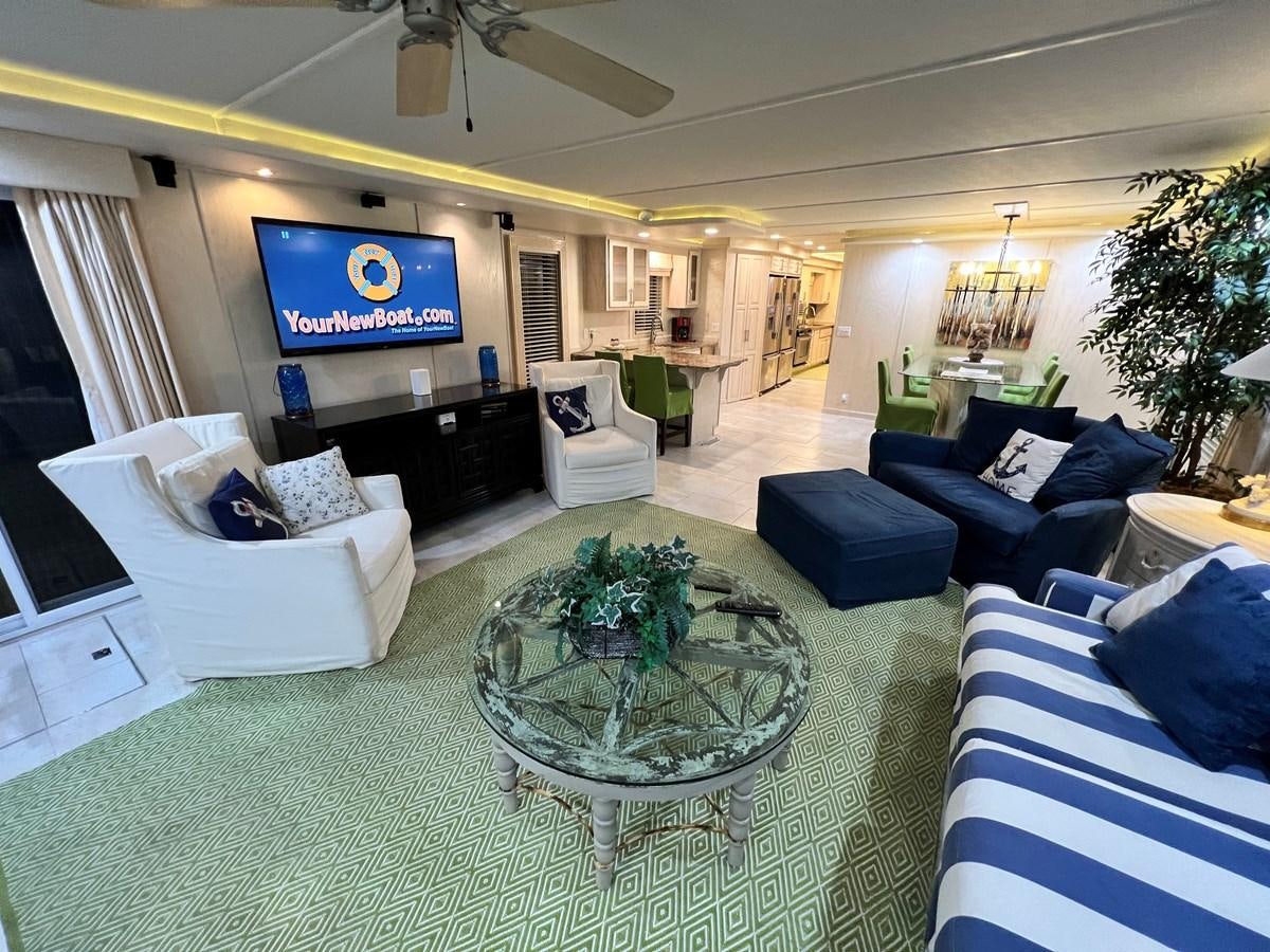 a large living room with a large screen aboard 2010/1995 STARDUST 20 X 95WB NLST Yacht for Sale