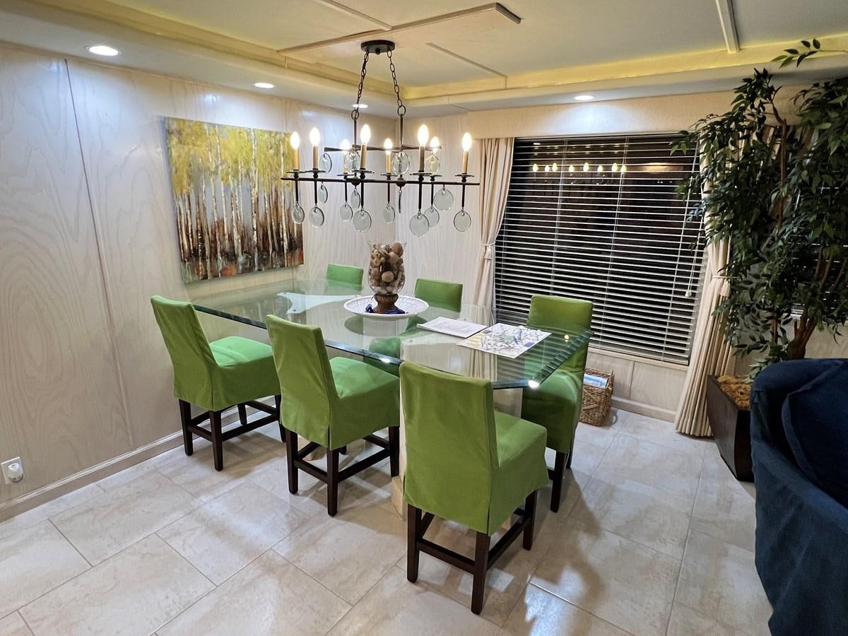 a dining room with green chairs aboard 2010/1995 STARDUST 20 X 95WB NLST Yacht for Sale