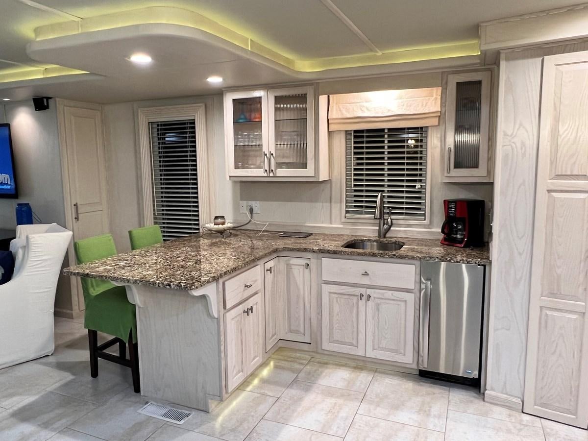 a kitchen with a sink and cabinets aboard 2010/1995 STARDUST 20 X 95WB NLST Yacht for Sale