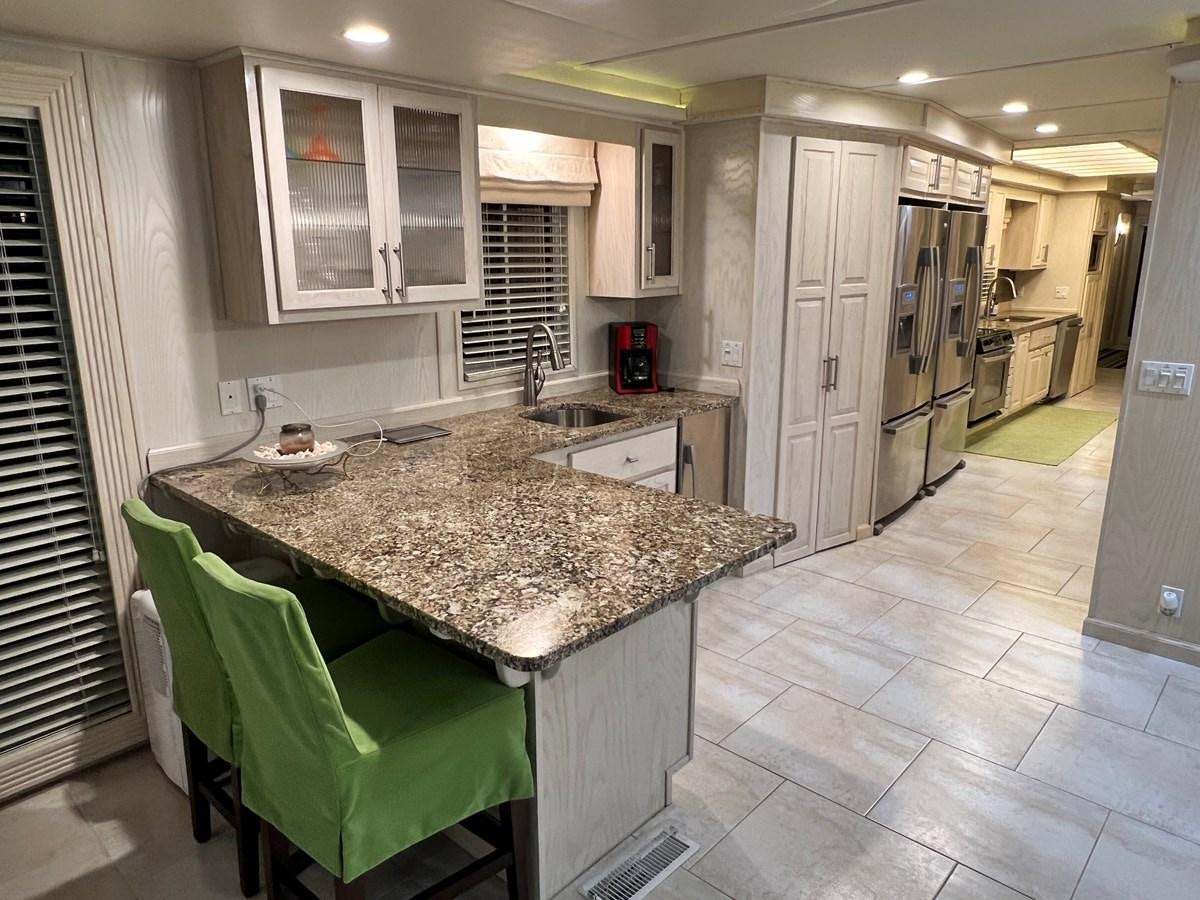a kitchen with a marble counter top aboard 2010/1995 STARDUST 20 X 95WB NLST Yacht for Sale