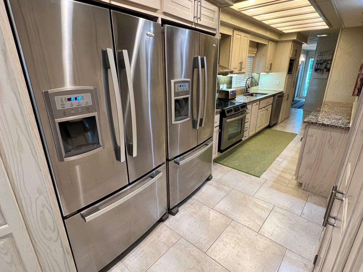 a kitchen with stainless steel appliances aboard 2010/1995 STARDUST 20 X 95WB NLST Yacht for Sale