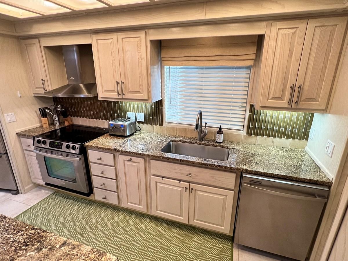 a kitchen with a sink and stove aboard 2010/1995 STARDUST 20 X 95WB NLST Yacht for Sale