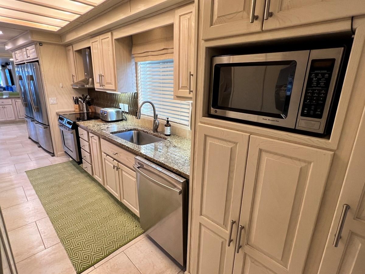 a kitchen with a microwave oven aboard 2010/1995 STARDUST 20 X 95WB NLST Yacht for Sale