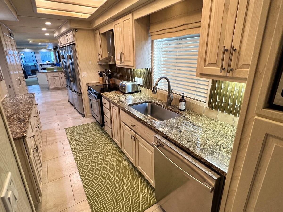 a kitchen with a marble counter top aboard 2010/1995 STARDUST 20 X 95WB NLST Yacht for Sale