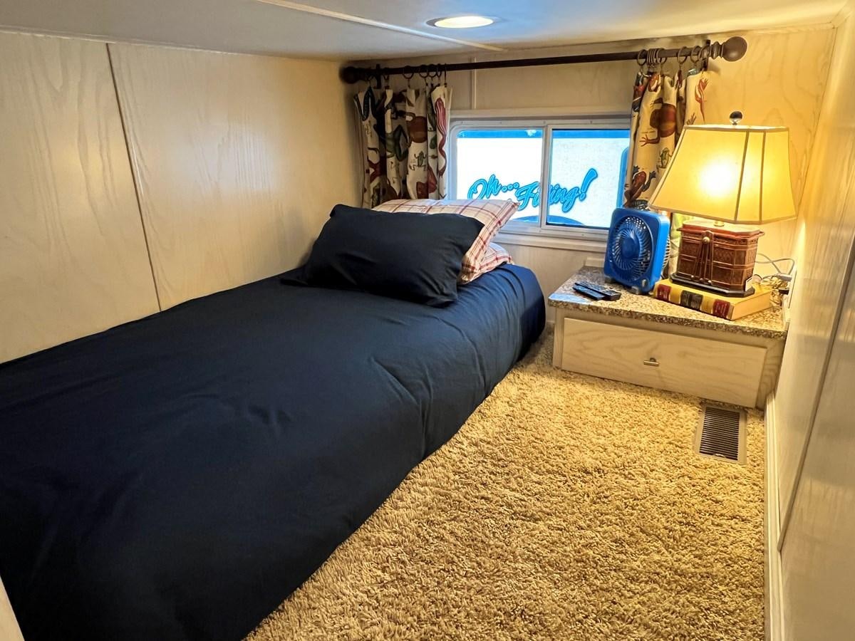 a bedroom with a bed and a lamp aboard 2010/1995 STARDUST 20 X 95WB NLST Yacht for Sale