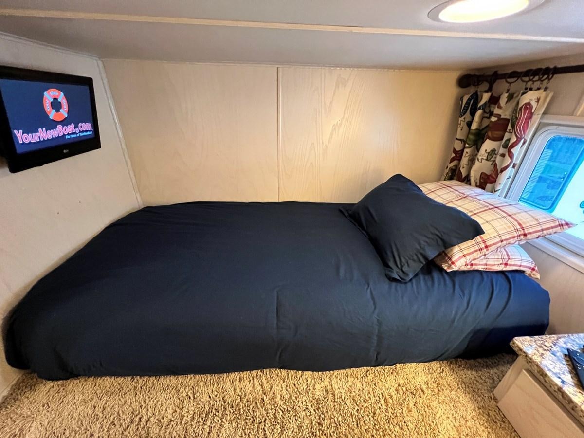 a black couch in a room aboard 2010/1995 STARDUST 20 X 95WB NLST Yacht for Sale