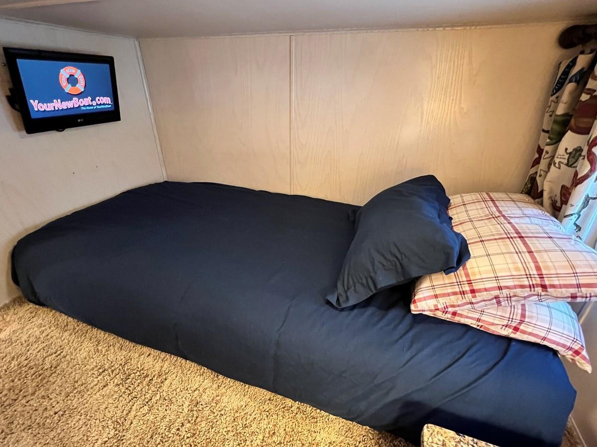 a couch with a television on the wall aboard 2010/1995 STARDUST 20 X 95WB NLST Yacht for Sale