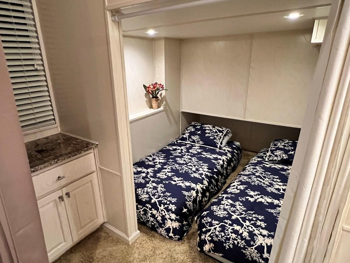 a bedroom with a bed and a dresser aboard 2010/1995 STARDUST 20 X 95WB NLST Yacht for Sale