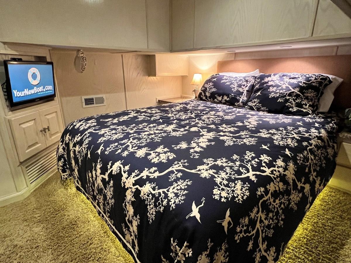 a bed with a black comforter aboard 2010/1995 STARDUST 20 X 95WB NLST Yacht for Sale