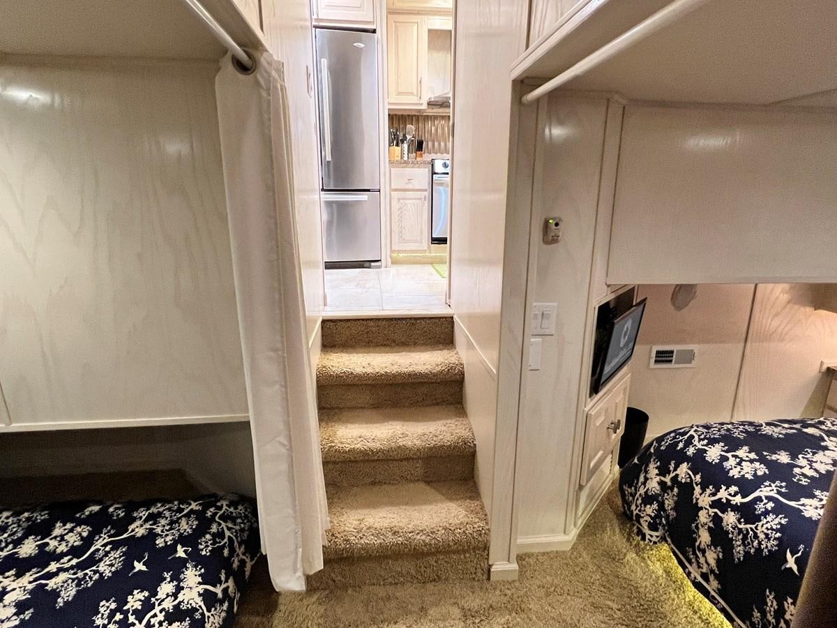 a hallway with a bed and a door aboard 2010/1995 STARDUST 20 X 95WB NLST Yacht for Sale