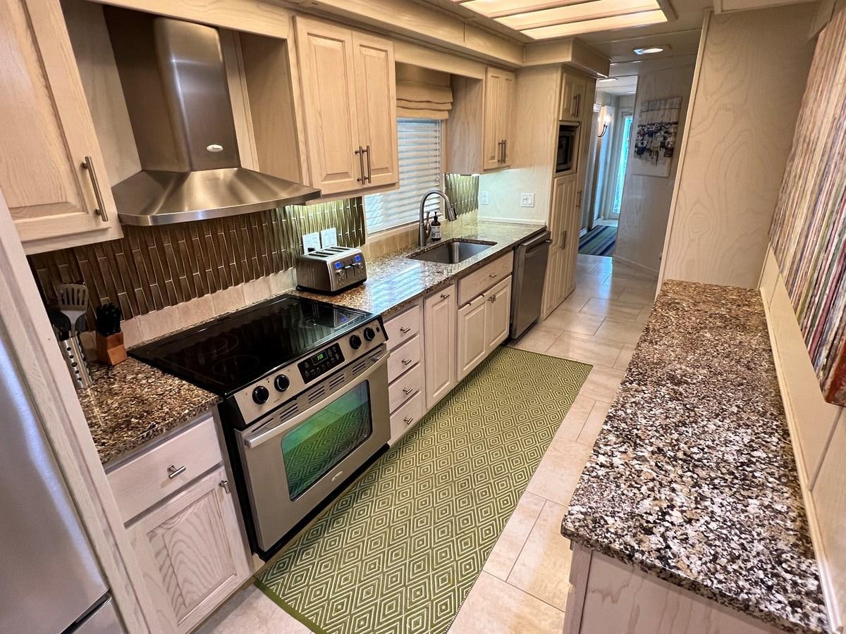 a kitchen with a marble counter top aboard 2010/1995 STARDUST 20 X 95WB NLST Yacht for Sale