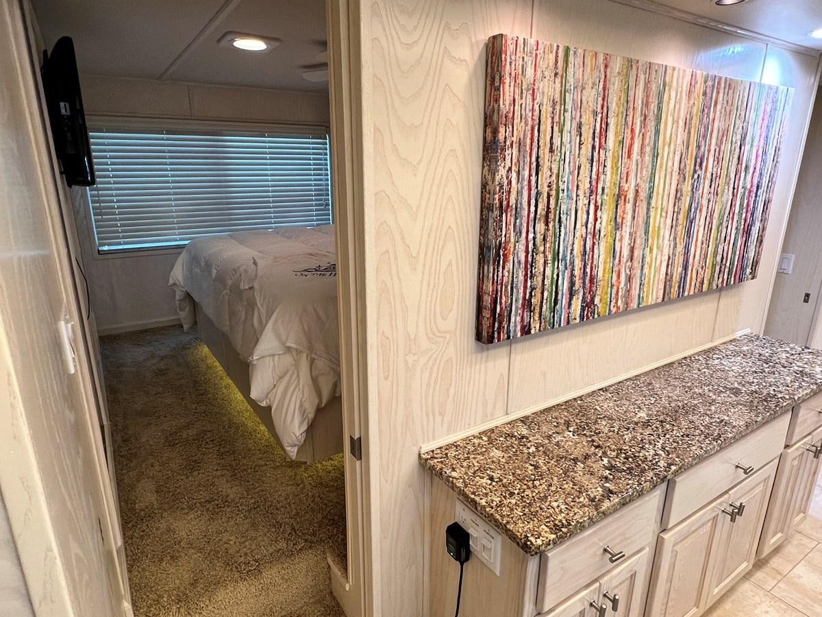 a bedroom with a bed and a desk aboard 2010/1995 STARDUST 20 X 95WB NLST Yacht for Sale