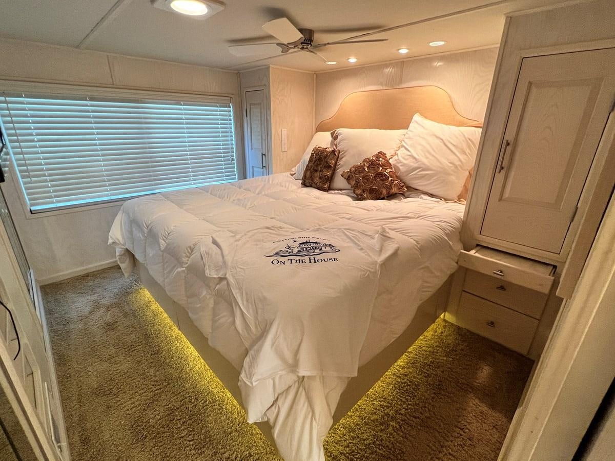 a bed with white sheets and pillows aboard 2010/1995 STARDUST 20 X 95WB NLST Yacht for Sale