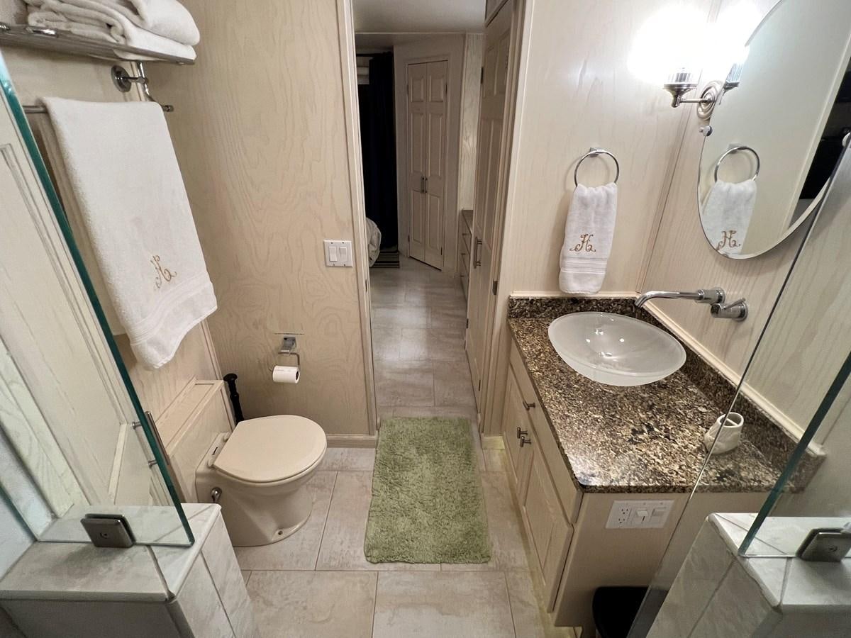 a bathroom with a sink toilet and a mirror aboard 2010/1995 STARDUST 20 X 95WB NLST Yacht for Sale