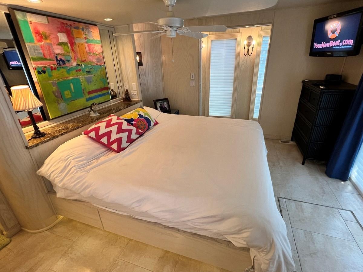 a bedroom with a large bed aboard 2010/1995 STARDUST 20 X 95WB NLST Yacht for Sale