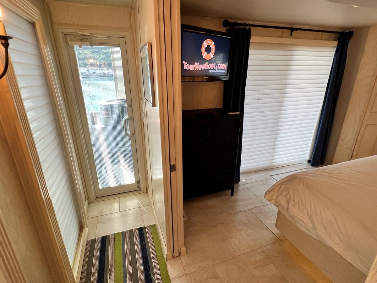 a tv on a wall in a room with a bed and a window aboard 2010/1995 STARDUST 20 X 95WB NLST Yacht for Sale