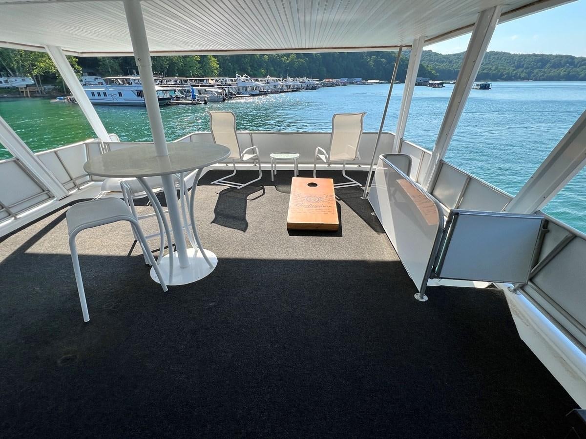 a table and chairs on a boat aboard 2010/1995 STARDUST 20 X 95WB NLST Yacht for Sale