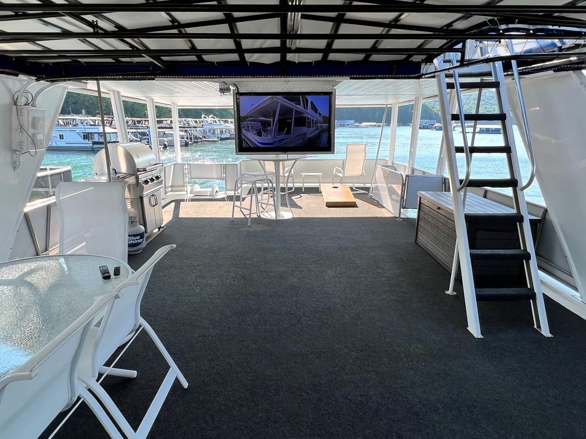 a room with a large screen aboard 2010/1995 STARDUST 20 X 95WB NLST Yacht for Sale