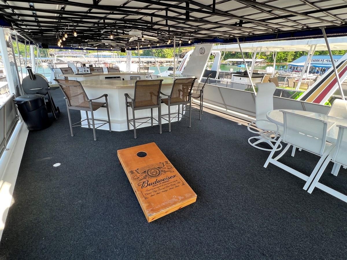 a table with chairs and tables aboard 2010/1995 STARDUST 20 X 95WB NLST Yacht for Sale