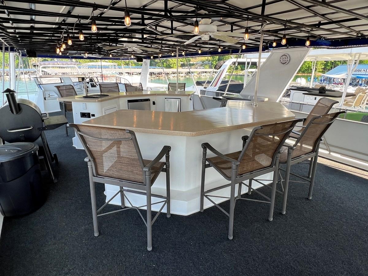 a table and chairs in a room aboard 2010/1995 STARDUST 20 X 95WB NLST Yacht for Sale